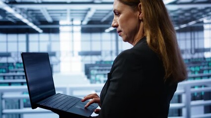 Poster - technician doing checkup, inputting data on laptop of needed server hub fixes. close up of employee 