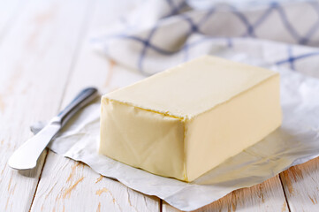 Wall Mural - fresh butter and knife on a kitchen table, selective focus.