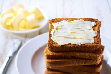 Wall Mural - Stack of sandwich bread slices with butter, selective focus.