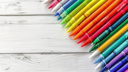 Wall Mural - Colorful markers in a flat lay arrangement with space for text on a white wooden background showcasing a rainbow palette