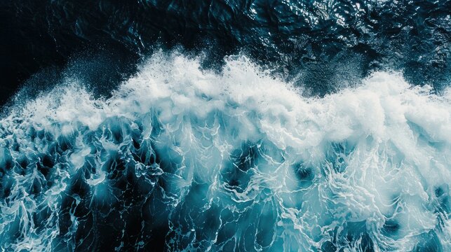 aerial top view background photo of ocean sea water white wave splashing in the deep sea