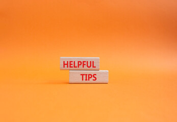 Wall Mural - Helpful tips symbol. Wooden blocks with words Helpful tips. Beautiful orange background. Business and Helpful tips concept. Copy space.