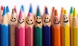 © Daniela - Linear arrangement of colored pencils with drawn happy faces, symbolizing creativity, fun and artistry in education