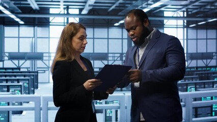 Poster - Team of admin in server hub check recovery plan, monitoring data center energy consumption across components. Coworkers ensures sensors are functioning optimally, doing routine disk checks, camera A