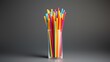 © BozStock - A glass full of colorful straws on a solid gray background. The straws are arranged in a haphazard fashion.