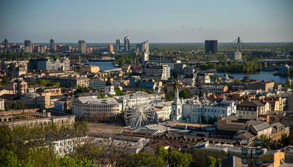 kyiv cityscape with ferris wheel and river in the background with buildings