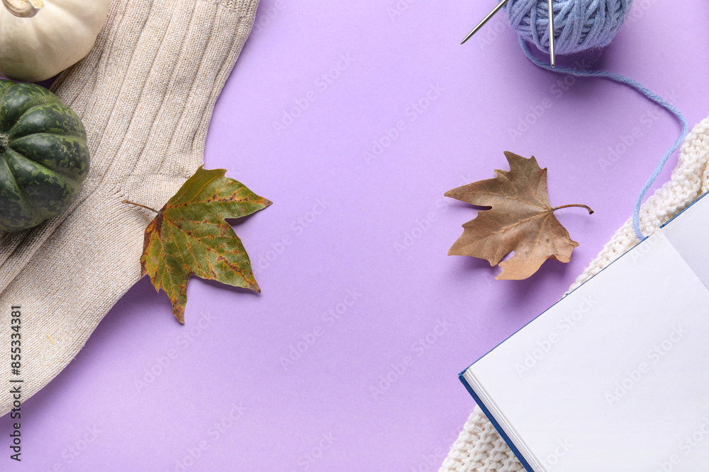 Composition with book, clothes and autumn decor on lilac background