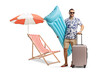 © Ljupco Smokovski - Full length portrait of a man holding an inflatable mattress and a suitcase by a beach chair