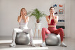 © Pixel-Shot - Beautiful mature woman with physiotherapist doing face building exercise on fitballs in rehabilitation center