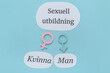 © Pixel-Shot - Text SEXUELL UTBILDNING (Swedish for Sexual Education) with male and female symbols on blue background