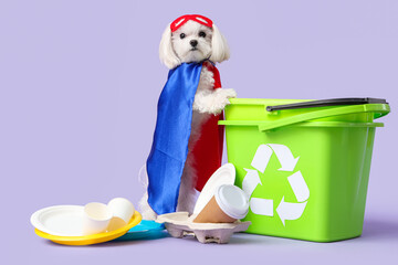 Wall Mural - Cute little dog in eco superhero costume with trash bins and garbage on lilac background