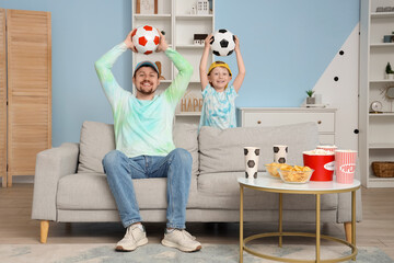 Wall Mural - Young father and son with soccer balls at home