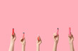 © Pixel-Shot - Many hands holding electronic cigarettes on pink background