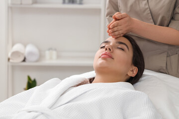 Wall Mural - Beautiful young woman getting facial massage in salon, closeup