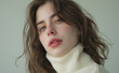 © Ice Cream Paradise - A photo of a young woman with wavy brown hair, green eyes and pale skin wearing a white turtleneck sweater against a neutral background