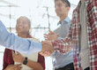 © Katsiaryna - Young startup in casual clothes shaking hands in a modern office space by the window.