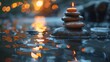 © LittleDreamStocks - A single candle flame atop a stack of stones in a still pond at sunset.
