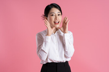 Wall Mural - Portrait of beautiful Asian female businessman posing on pink background