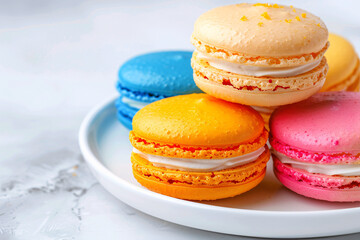 Poster - French macaron cookies in assorted colors on a white plate Stock Photo with copy space Isolated on white background