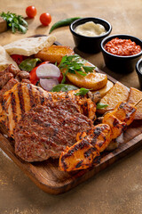 Assorted mix grills with tikka boti seekh kabab of chicken, beef, lamb, mutton bbq platter served in dish isolated on table top view of arabian food