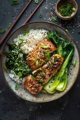 Wall Mural - Top view of an Asian dish with rice, bok choy and a seared fillet on a dark background. Professional food photography in the style of an Asian-inspired still life