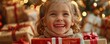 © INsprThDesign - A joyful child smiles while holding a Christmas gift, surrounded by festive decorations and lights.