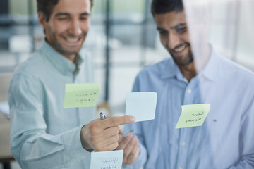 Wall Mural - two successful businessmen in the office discuss a plan on stickers