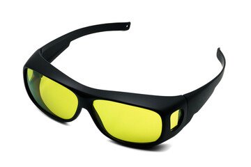 Side view of cool black sports sunglasses with yellow lenses for filtering light on white isolated background studio shots. Glasses for product design on white background.