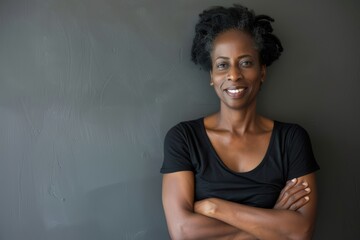 Wall Mural - Portrait of a jovial afro-american woman in her 40s with arms crossed on minimalist or empty room background