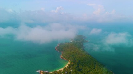 Wall Mural - Aerial drone view of tropical exotic rain forest island jungle in morning light covered fogy clouds.