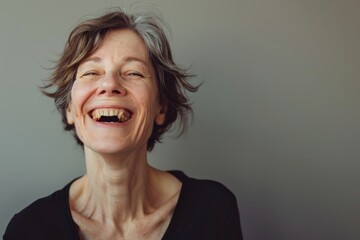 Wall Mural - Portrait of a grinning caucasian woman in her 60s laughing isolated in minimalist or empty room background