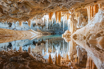 Generative ai on theme of a large beautiful sharp stalactites hanging down from deep mountain cave