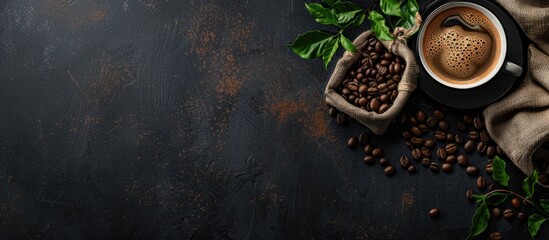 Fototapete - cup of coffee and coffee beans in a sack on dark background, top view. Copy space image. Place for adding text or design