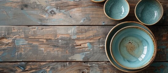 Poster - Empty bowls and cups on a wooden table. with copy space image. Place for adding text or design
