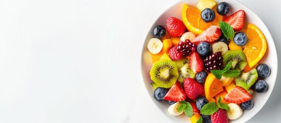Poster - Bowl of healthy fresh mixed fruit salad isolated on white background. Copy space image. Place for adding text or design