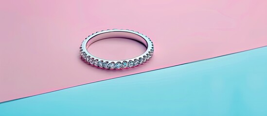 Poster - Casual style white gold ring with diamonds Isolated on pastel background. Silver wedding ring band with gemstones. with copy space image. Place for adding text or design