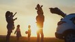 © maxximmm - happy family. children stand together next to the car silhouette of the sunset in the park. family dream concept. happy family standing with sunlight, back watching the journey travel in the park