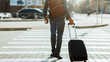 © Prostock-studio - Cropped of black businessman crossing road with suitcase and backpack on his shoulder, catching taxi