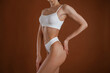 © standret - Showing brand new underwear. Woman with slim body shape is posing against background