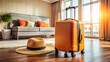 © Wanlop - Modern orange and black suitcase and straw hat resting on a plush hotel room floor, exuding relaxation and excitement for a leisurely getaway.