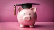 © Wanlop - A pink piggy bank adorned with a miniature graduation cap sits on a pink background, symbolizing college savings and scholarship success.