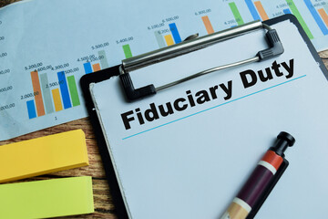 Wall Mural - Concept of Fiduciary Duty write on paperwork isolated on wooden background.