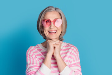 Canvas Print - Photo portrait of retired woman look dreamy empty space heart sunglass dressed stylish striped clothes isolated on blue color background