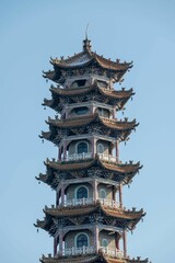 Wall Mural - Close-up of a traditional Chinese pagoda with intricate details against a clear blue sky.