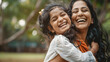 © Daniel - Happy indian mother having fun with her daughter outdoor - Family people and love concept - Focus on mum face