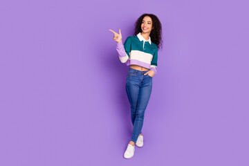 full body portrait of lovely young girl direct finger empty space wear shirt isolated on purple colo
