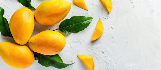 Sticker - A yellow ripe mango with leaves placed on a white scene. pastel background. Copy space image. Place for adding text and design