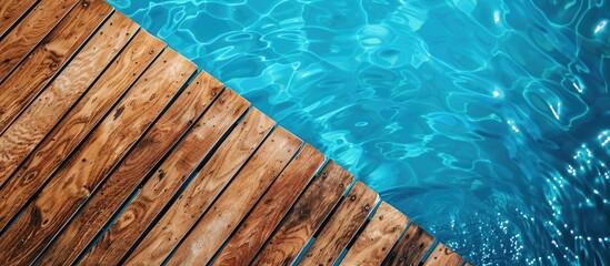 Poster - Diagonal lines of wood in detail decking and blue water swimming pool abstract background. Copy space image. Place for adding text and design