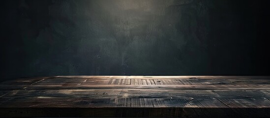 Poster - Wooden table in a dark room. Copy space image. Place for adding text and design