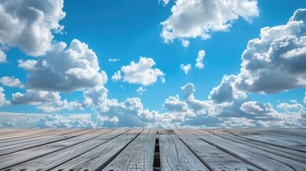 Wall Mural - Wooden walkway under the clear blue sky filled with fluffy white clouds